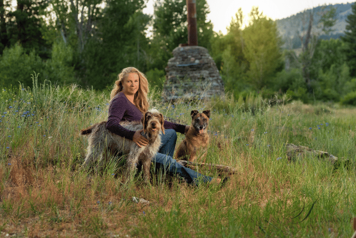 Woman with two dogs in field
