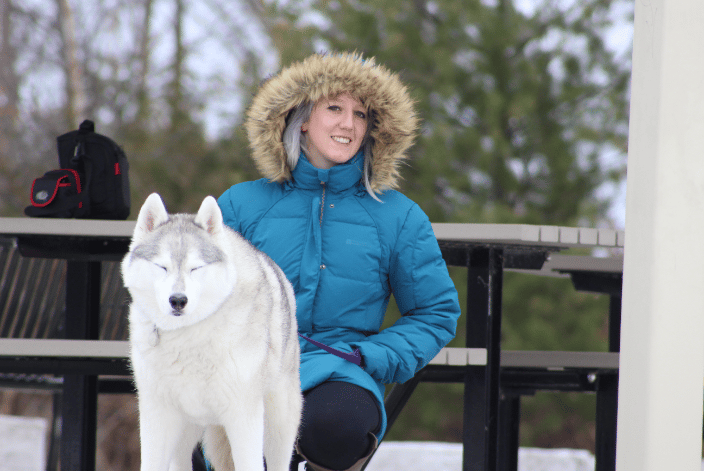 Dog Trainer and husky in snow